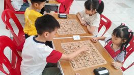Young children playing Xiangqi at an organized event in March 2026