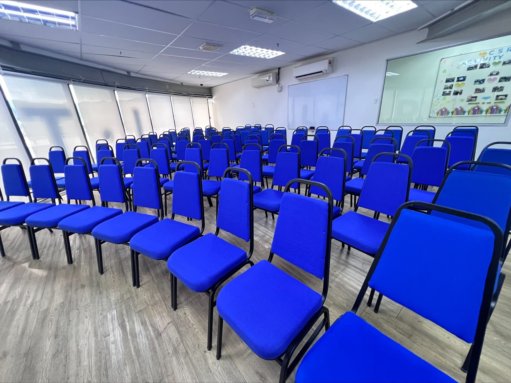 Wide view of blue seating and the whiteboard at ITPA Penang