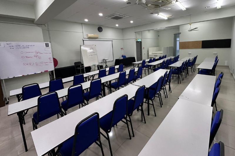 Large ITPA Kuala Lumpur room with classroom-style tables and blue chairs