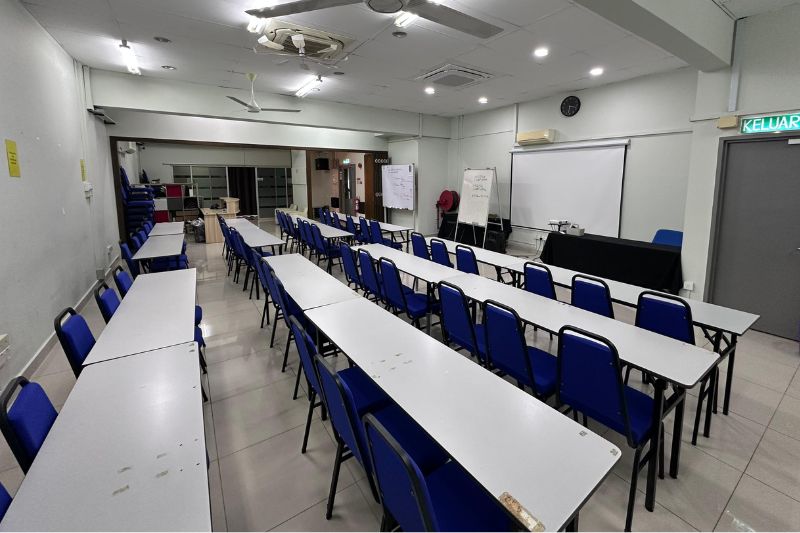 Kuala Lumpur training room with long tables arranged toward a projector screen