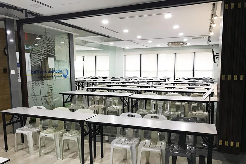 Large KL training hall with many tables and seats