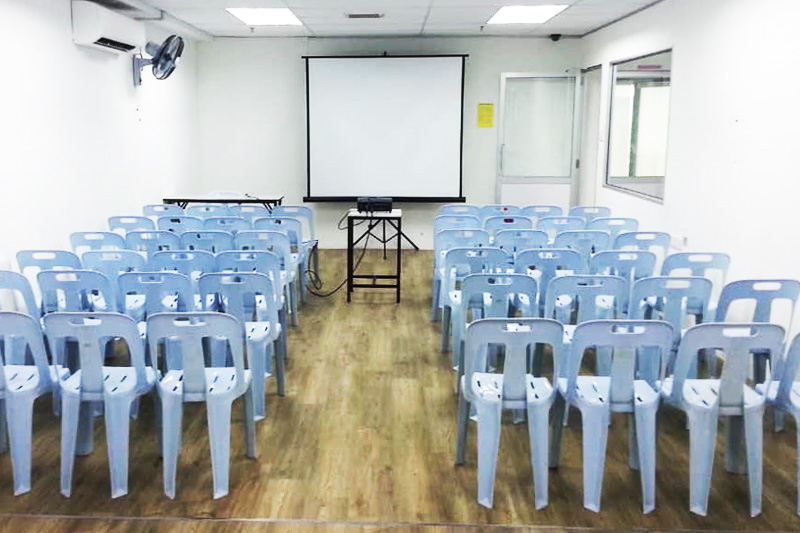 Penang training room arranged with rows of chairs facing a projector screen