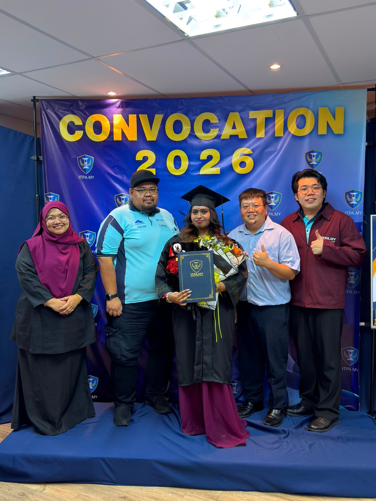 Graduate with the ITPA team at the 2026 convocation ceremony